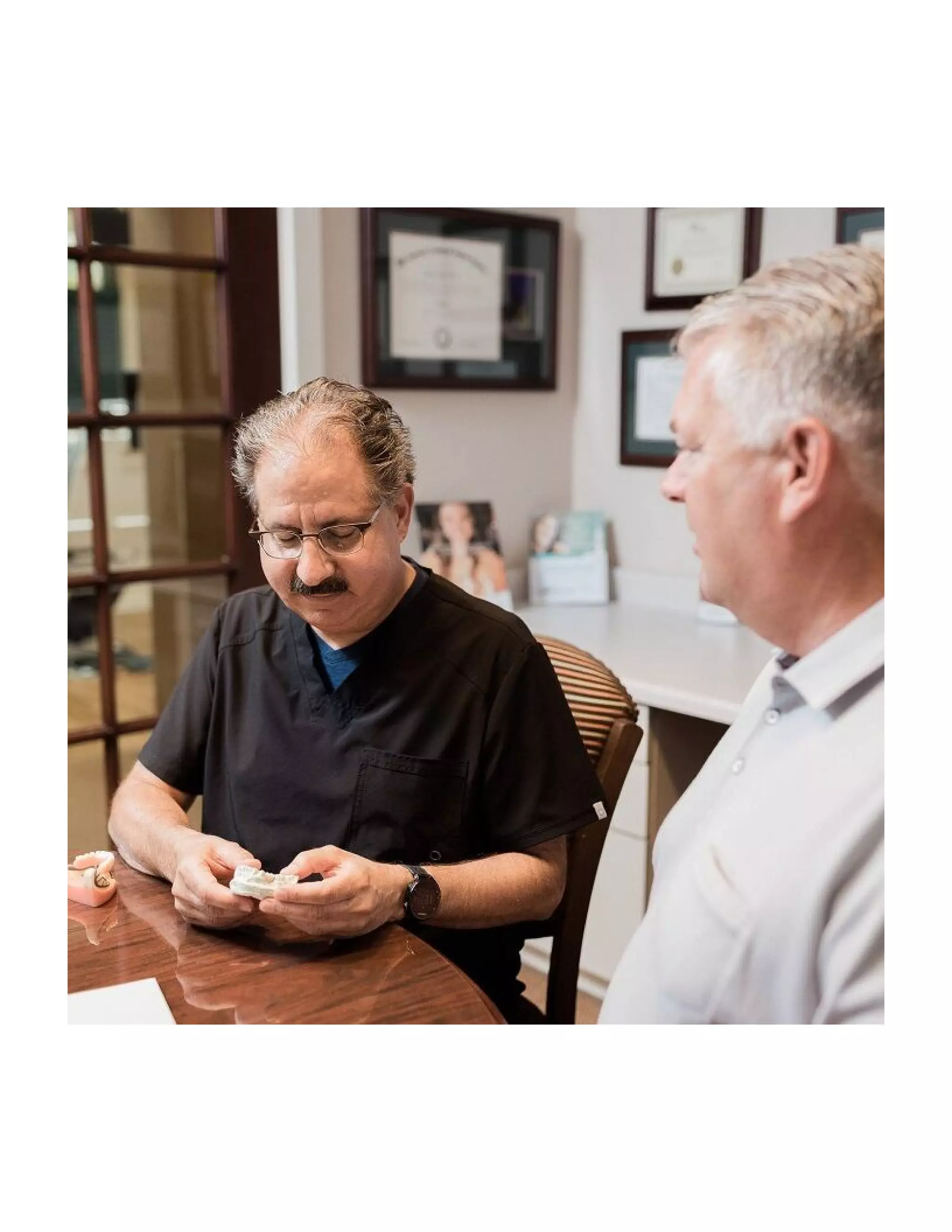 Sioux Falls dentist explaing the dental implant procedure at Kusek