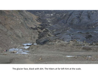The glacier face, black with dirt. The hikers at far left hint at the scale.