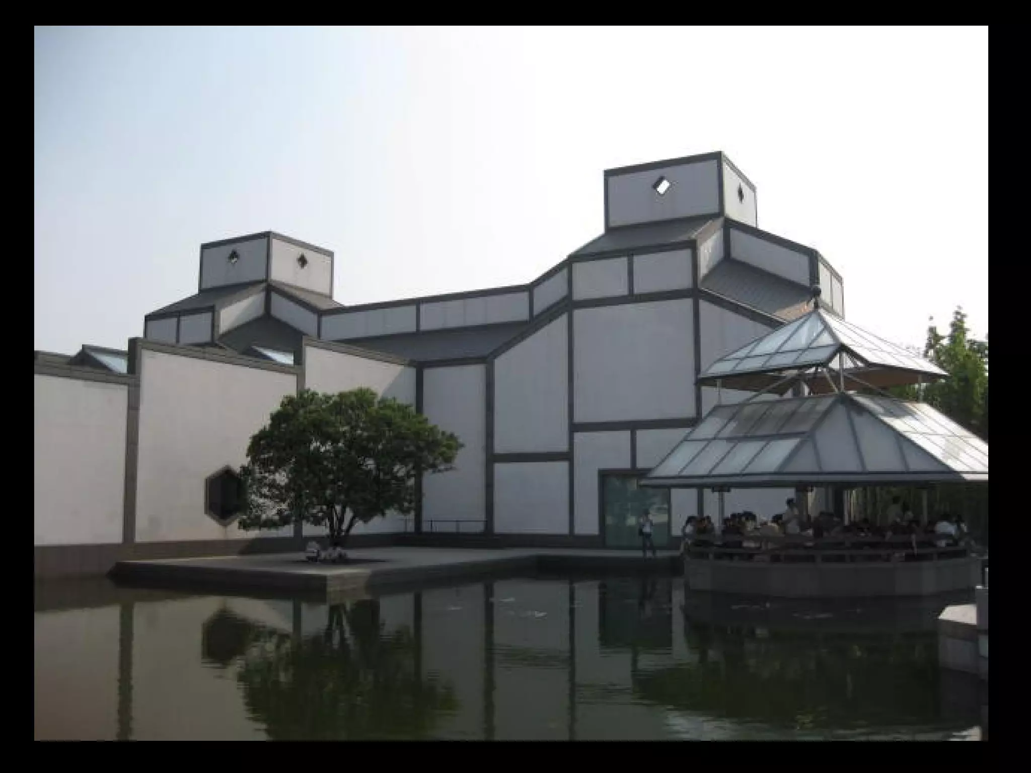 The Hysolar Institute at the University of Stuttgart, Germany (1988, G. Behnish and Frank Stepper) reflects
the spirit of deconstruction, it looks like a picture puzzle of a building - it is a playful open style of building
with modern light materials. It reflects a play of irregular spaces like a collage using oblique angles causing
the structure to look for order. The building consists of two rows of prefabricated stacked metal
containers arranged in some haphazard twisted fashion, together with a structural framework
enclosed with sun collectors. The interior space is open at the ends and covered by a sloped roof
structure. The bent linear element gives the illusion of an arch with unimportant almost ugly
anchorage to the ground.
 