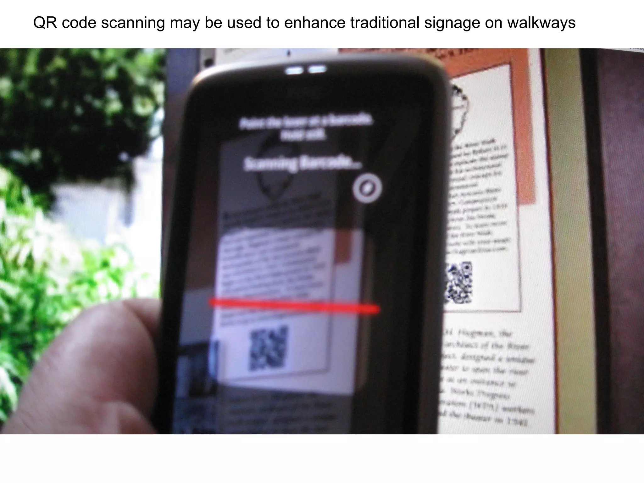 QR code scanning may be used to enhance traditional signage on walkways  