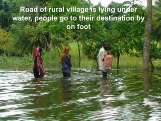 Road of rural village is lying under water, people go to their destination by on foot