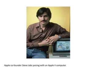 Apple co-founder Steve Jobs posing with an Apple II computer.
 