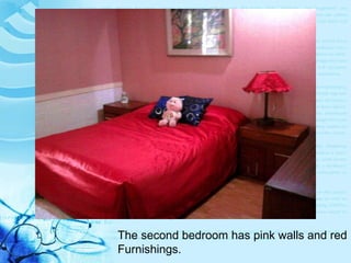 The second bedroom has pink walls and red Furnishings. 