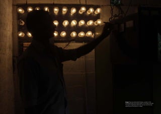 Image: Raju Arumathamattal Devasiya, operator of the
Pathanpara 5kW micro-hydro system, in his office in the hills.
The board of lightbulbs behind him acts as a dummy load,
absorbing any fluctuations in voltage.
 