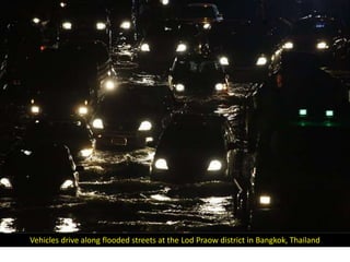 Vehicles drive along flooded streets at the Lod Praow district in Bangkok, Thailand
 