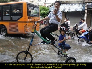 A Thai man takes pictures with his son on a custom-built tricycle designed to go through
                           floodwaters in Bangkok, Thailand
 