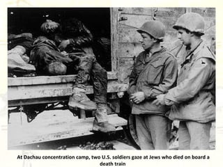 At Dachau concentration camp, two U.S. soldiers gaze at Jews who died on board a death train   