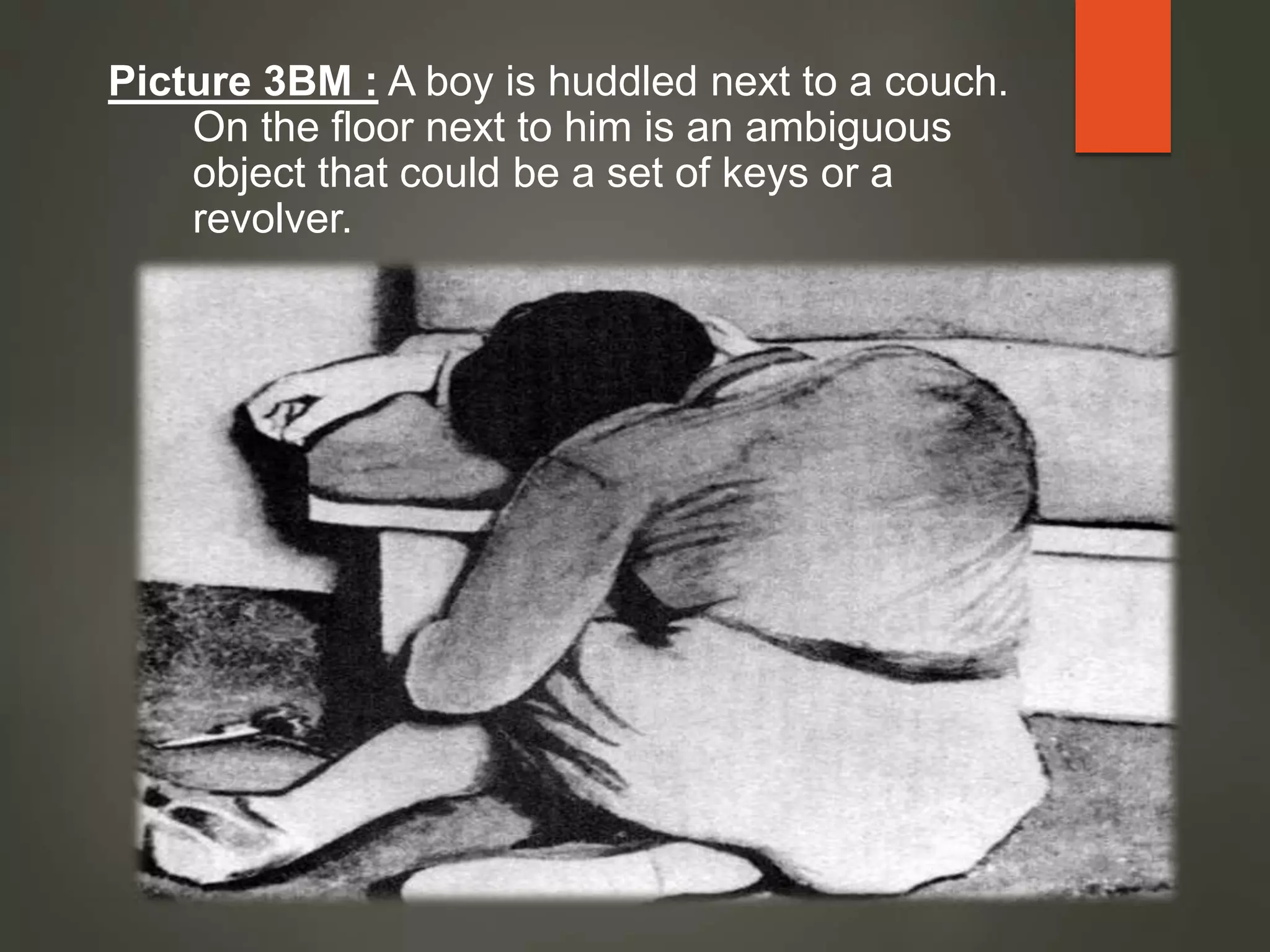 Picture 3BM : A boy is huddled next to a couch.
On the floor next to him is an ambiguous
object that could be a set of keys or a
revolver.
 