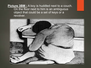 Picture 3BM : A boy is huddled next to a couch.
On the floor next to him is an ambiguous
object that could be a set of keys or a
revolver.
 