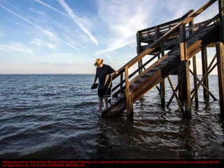 Visiting the area for the first time, 64-year-old Fran Glod of Oswego, N.Y, walks down the steps to the beach which is cov...