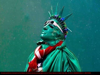A street performer dressed as the Statue of Liberty stands among light snow in Times Square in New York, Dec. 10, 2014. AN...