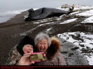 Molly Pederson, right, and her daughter Laura Patkotak take a picture as a bowhead whale caught by Alaska Native subsisten...