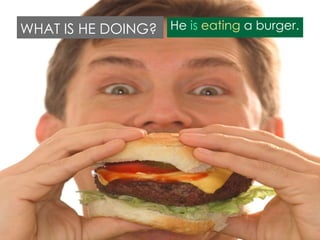 WHAT IS HE DOING? He is eating a burger.

 