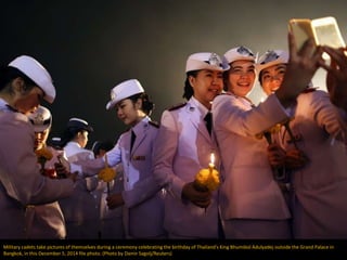 Military cadets take pictures of themselves during a ceremony celebrating the birthday of Thailand's King Bhumibol Adulyad...