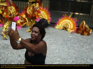 A reveller takes a selfie as she waits for the first night of the Carnival parade of samba schools in Rio de Janeiro's Sam...