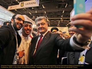 Ukrainian President Petro Poroshenko takes a selfie with an Emirati media representative at the International Defence Exhi...