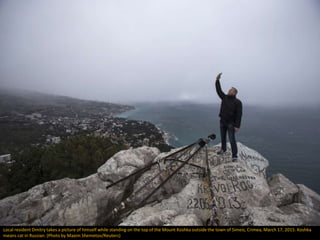 Local resident Dmitry takes a picture of himself while standing on the top of the Mount Koshka outside the town of Simeiz,...