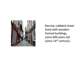 Narrow, cobbled street
lined with woodenframed buildings,
some 600 years old
(since 14th century).

 