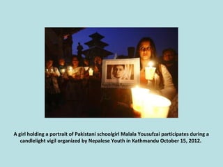 A girl holding a portrait of Pakistani schoolgirl Malala Yousufzai participates during a
candlelight vigil organized by Ne...