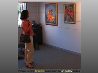 Person viewing Shalini’s paintings in an art gallery setting
 