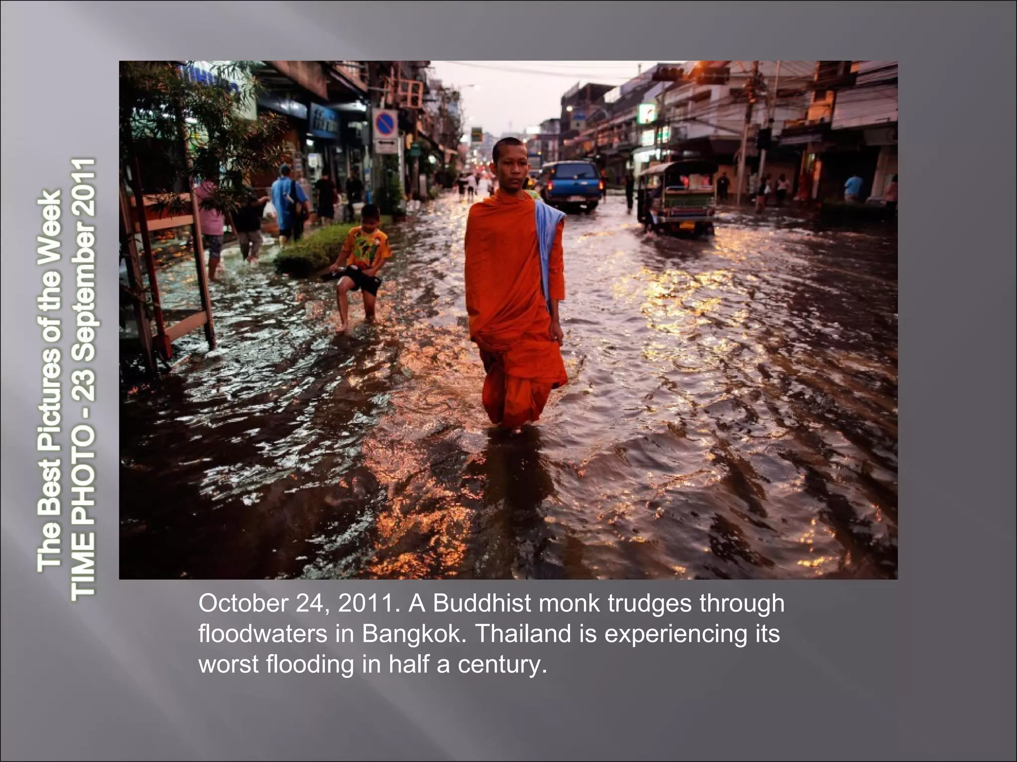 October 24, 2011. A Buddhist monk trudges through floodwaters in Bangkok. Thailand is experiencing its worst flooding in half a century.  