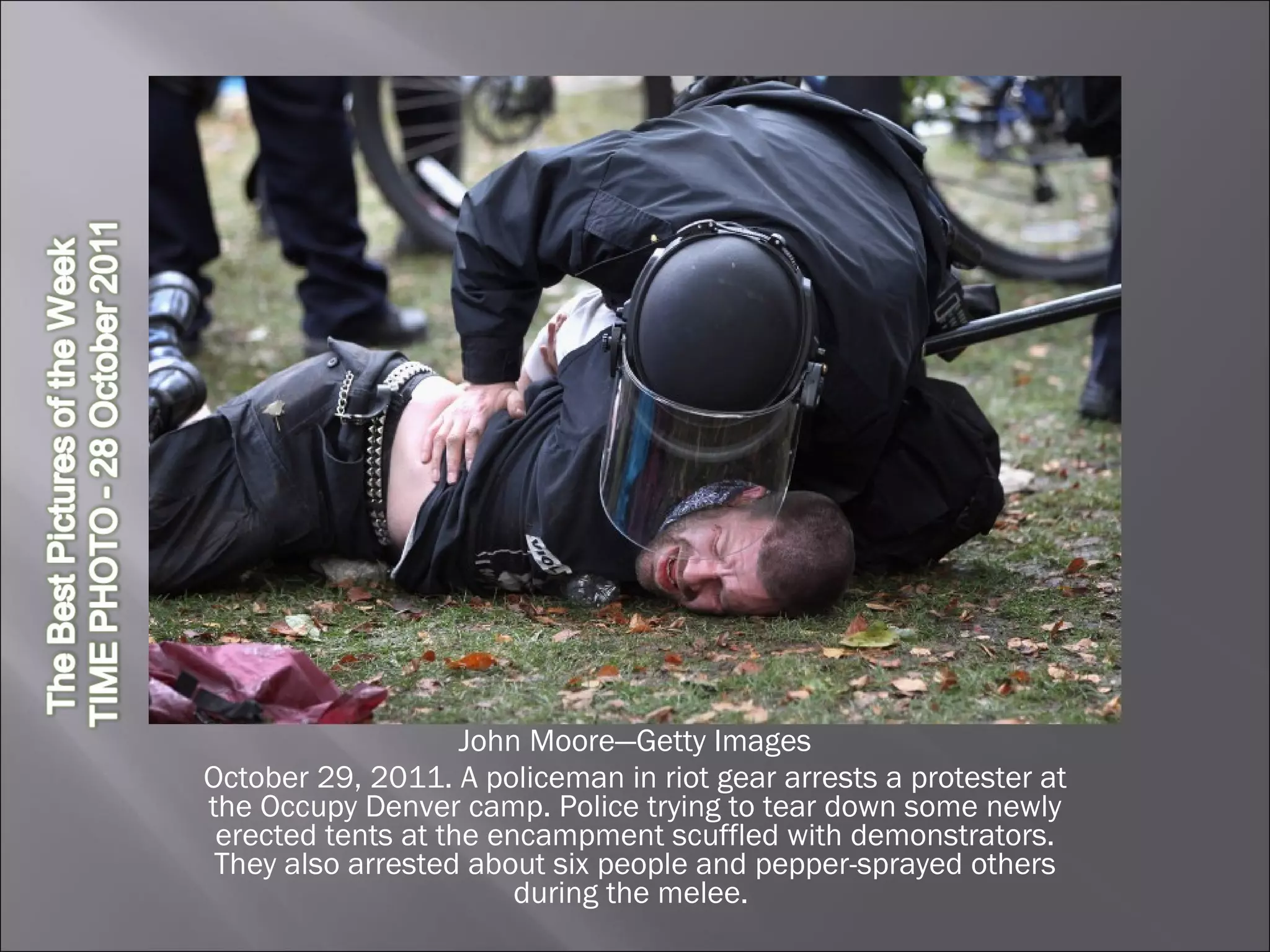 John Moore—Getty Images October 29, 2011. A policeman in riot gear arrests a protester at the Occupy Denver camp. Police trying to tear down some newly erected tents at the encampment scuffled with demonstrators. They also arrested about six people and pepper-sprayed others during the melee.  