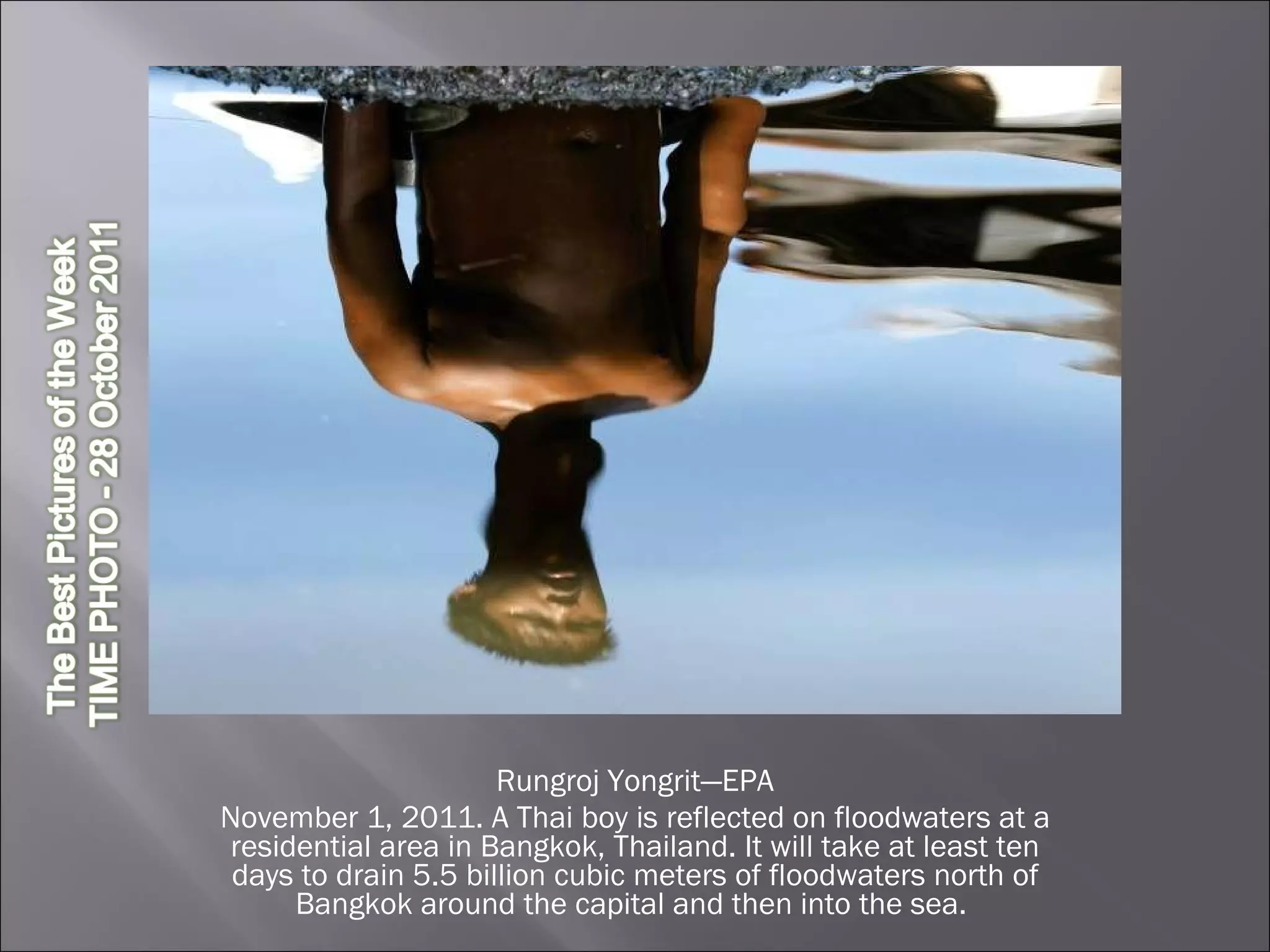 Rungroj Yongrit—EPA November 1, 2011. A Thai boy is reflected on floodwaters at a residential area in Bangkok, Thailand. It will take at least ten days to drain 5.5 billion cubic meters of floodwaters north of Bangkok around the capital and then into the sea.  