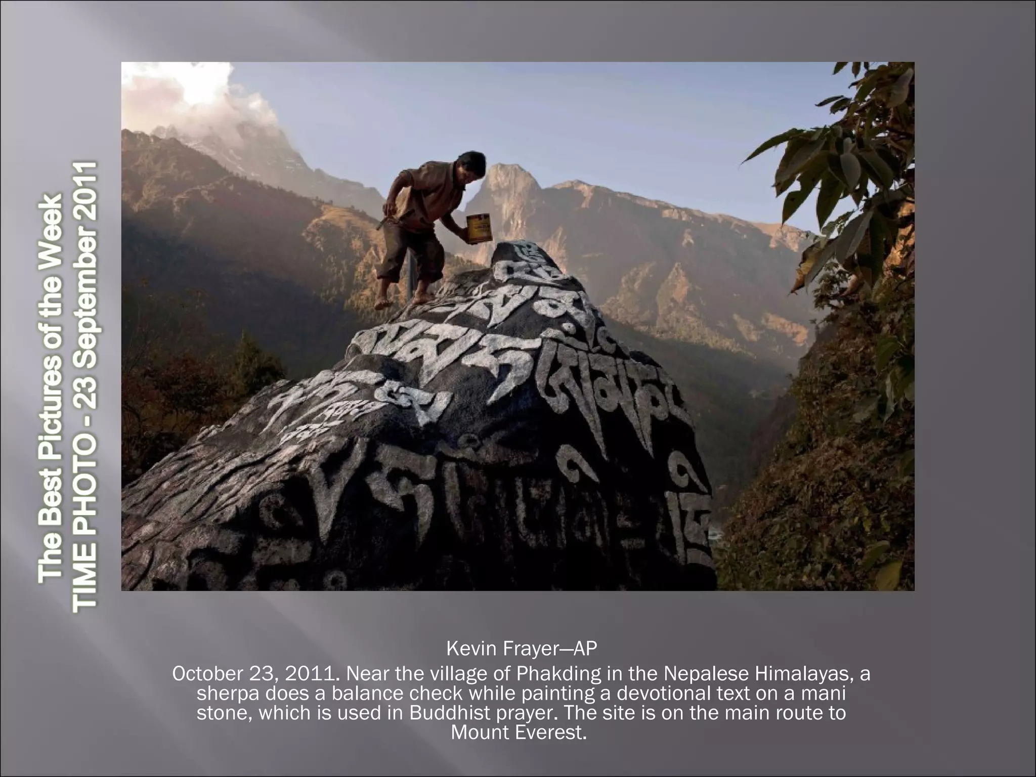 Kevin Frayer—AP October 23, 2011. Near the village of Phakding in the Nepalese Himalayas, a sherpa does a balance check while painting a devotional text on a mani stone, which is used in Buddhist prayer. The site is on the main route to Mount Everest.  