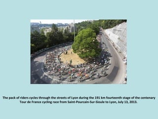 The pack of riders cycles through the streets of Lyon during the 191 km fourteenth stage of the centenary
Tour de France c...
