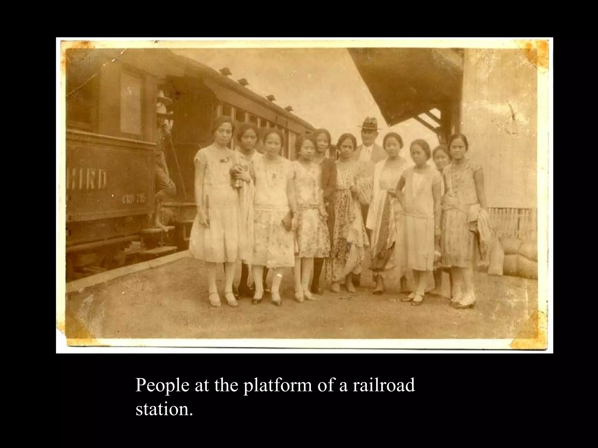 People at the platform of a railroad station. 