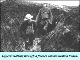 Officers walking through a flooded communication trench. 