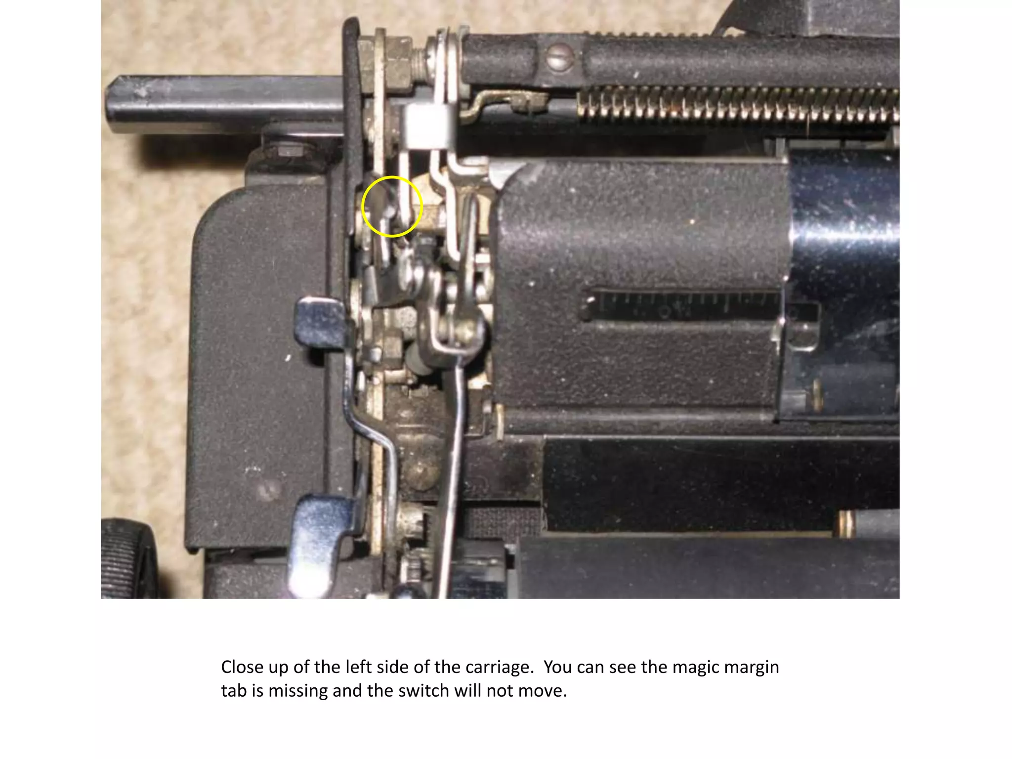 Close up of the left side of the carriage.  You can see the magic margin tab is missing and the switch will not move.