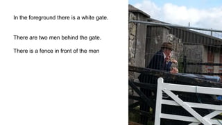 In the foreground there is a white gate.
There are two men behind the gate.
There is a fence in front of the men
 