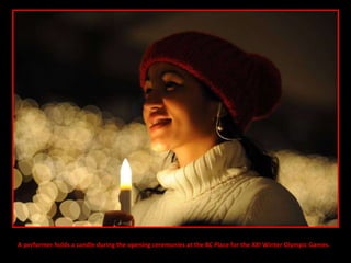 A performer holds a candle during the opening ceremonies at the BC Place for the XXI Winter Olympic Games. 