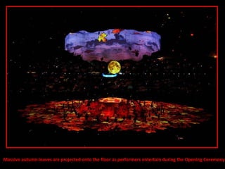 Massive autumn leaves are projected onto the floor as performers entertain during the Opening Ceremony  