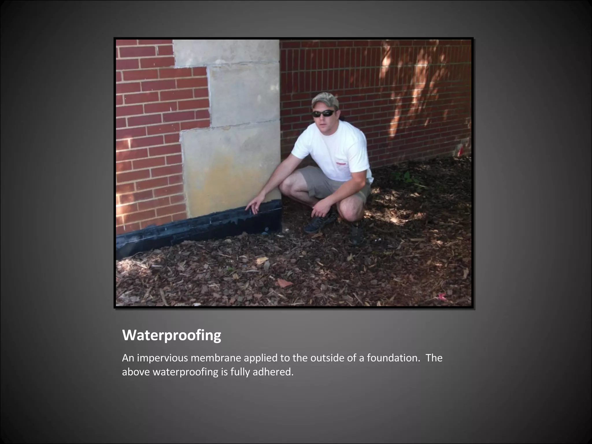 Waterproofing An impervious membrane applied to the outside of a foundation.  The above waterproofing is fully adhered.  