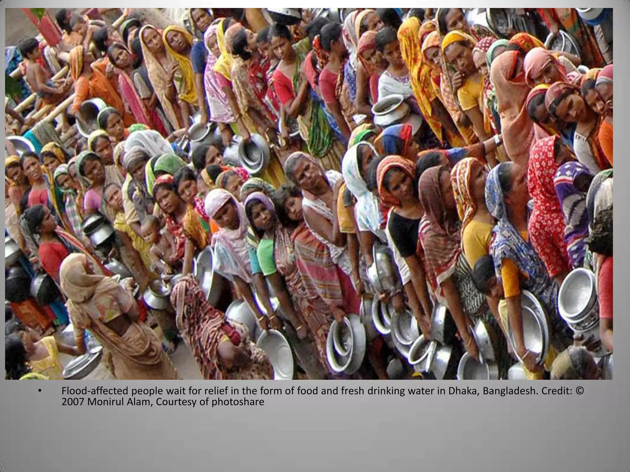 •   Flood-affected people wait for relief in the form of food and fresh drinking water in Dhaka, Bangladesh. Credit: ©
    2007 Monirul Alam, Courtesy of photoshare
 
