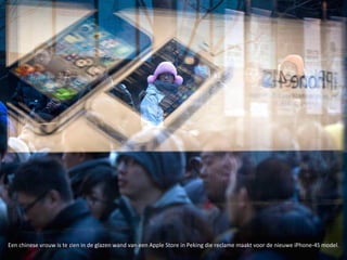 Een chinese vrouw is te zien in de glazen wand van een Apple Store in Peking die reclame maakt voor de nieuwe iPhone-4S model.
 