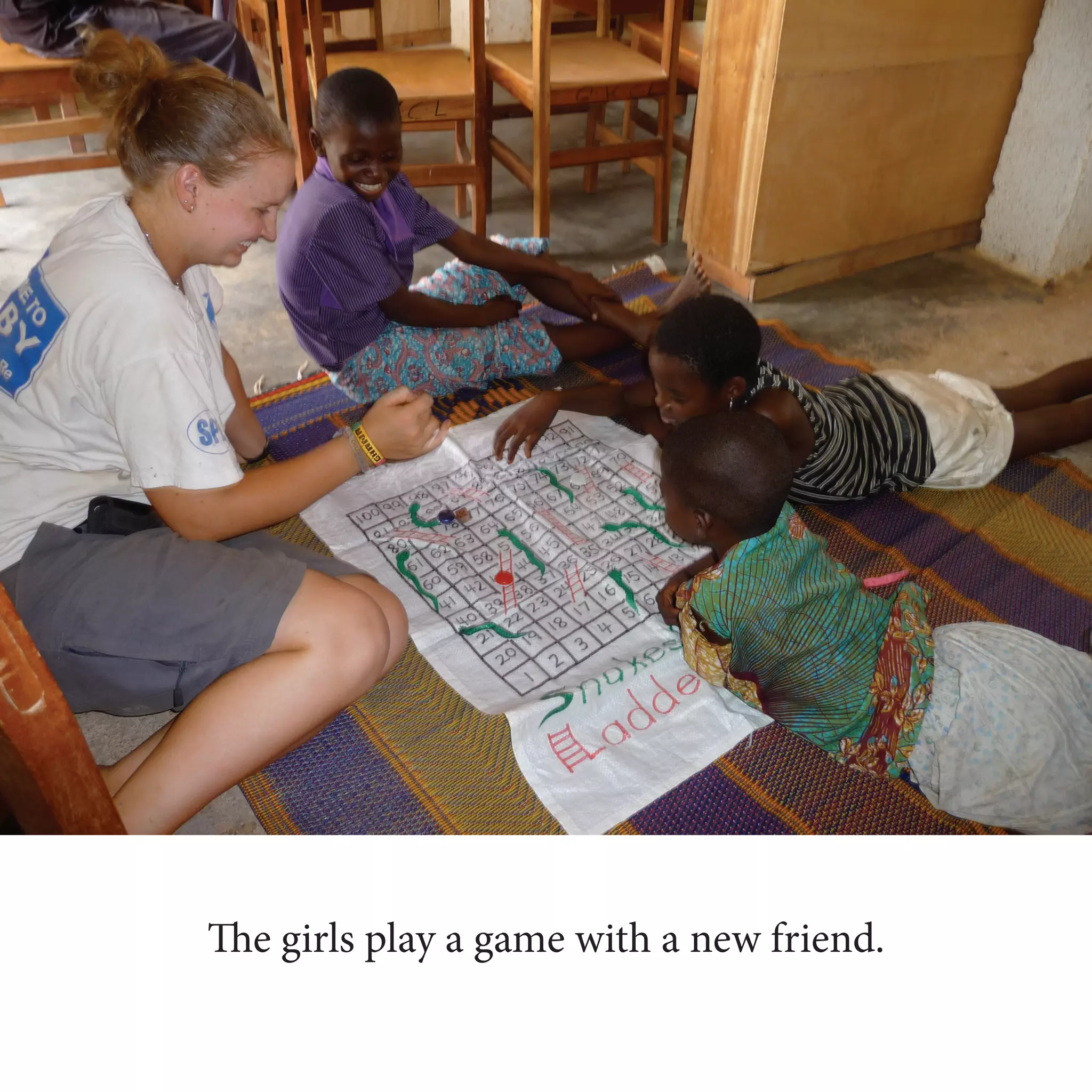 The girls play a game with a new friend.