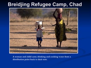 Breidjing Refugee Camp, Chad   A woman and child carry drinking and cooking water from a distribution point back to their tent.  
