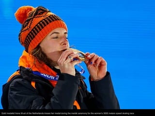 Gold medalist Irene Wust of the Netherlands kisses her medal during the medal ceremony for the women's 3000 meters speed s...