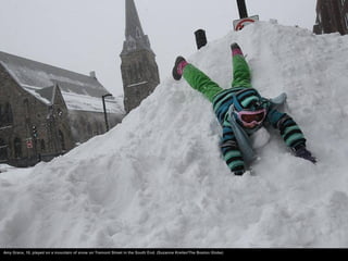Amy Grace, 10, played on a mountain of snow on Tremont Street in the South End. (Suzanne Kreiter/The Boston Globe)
 