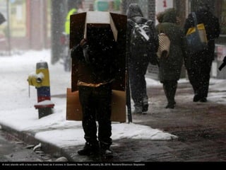 A man stands with a box over his head as it snows in Queens, New York, January 26, 2015. Reuters/Shannon Stapleton
 