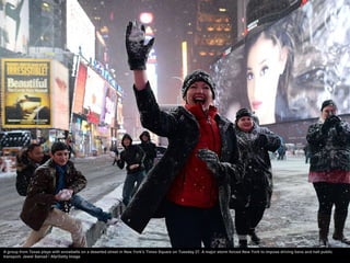 A group from Texas plays with snowballs on a deserted street in New York's Times Square on Tuesday 27. A major storm force...