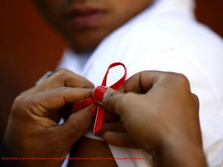 A red rib bon is put on the sleeves of a man by his friend to show support for people living with HIV.Reuters 
 