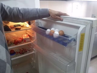 arranging / putting eggs into the fridge
