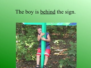 The boy is behind the sign.