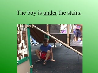 The boy is under the stairs.